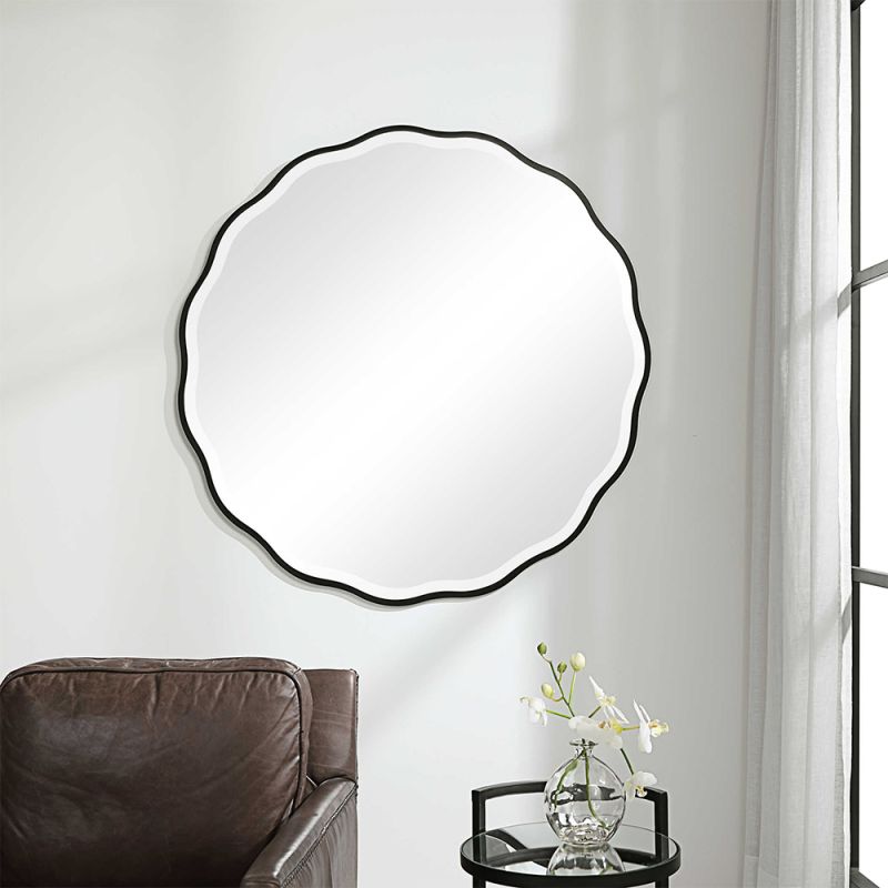 A stunning scalloped wall mirror by Uttermost