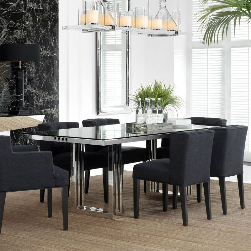 contemporary dining table with a transparent surface and stainless steel frame