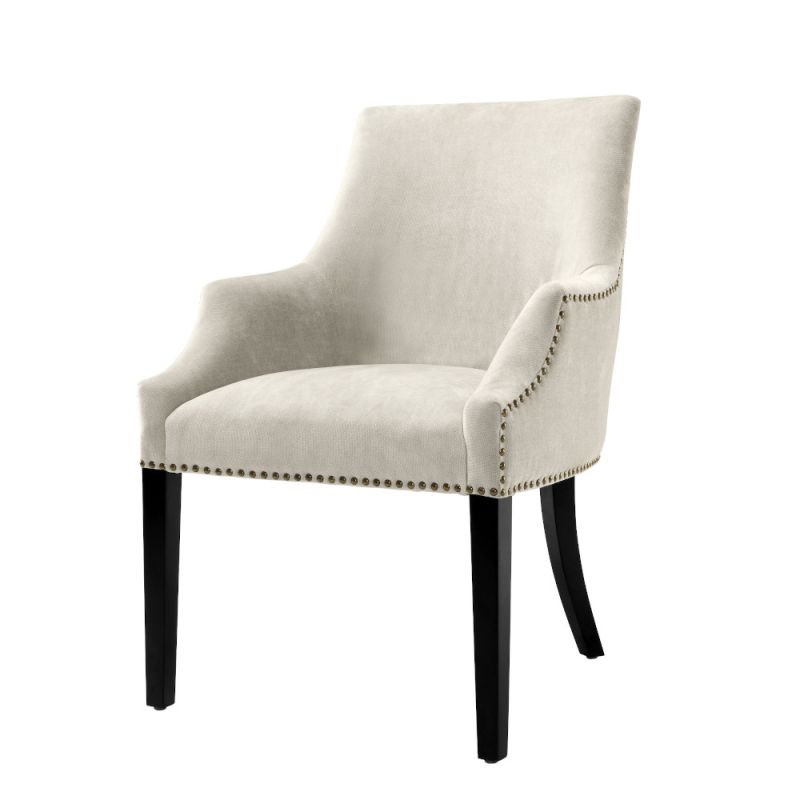 Luxury sand velvet dining chair with antique brass nail detailing and black legs
