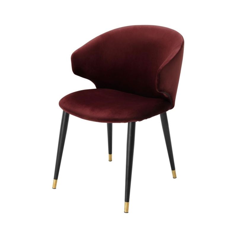 Luxury red velvet dining chair with black and gold tapered legs