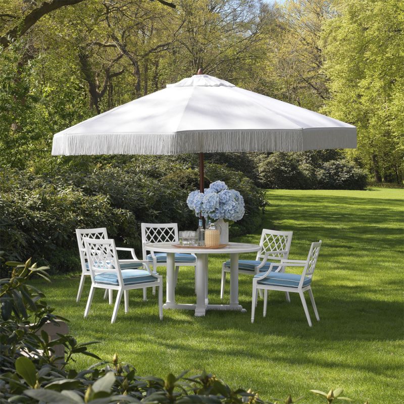 white dining chair with arms and a blue and white seat cushion - suitable for outdoor