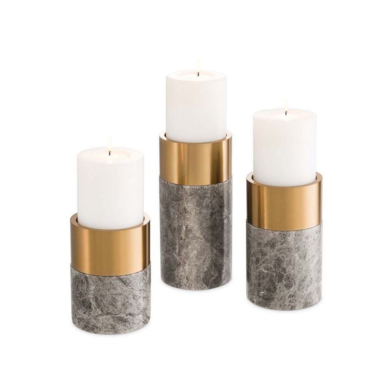 An elegant trio of candle holders in grey marble and brushed brass touches.