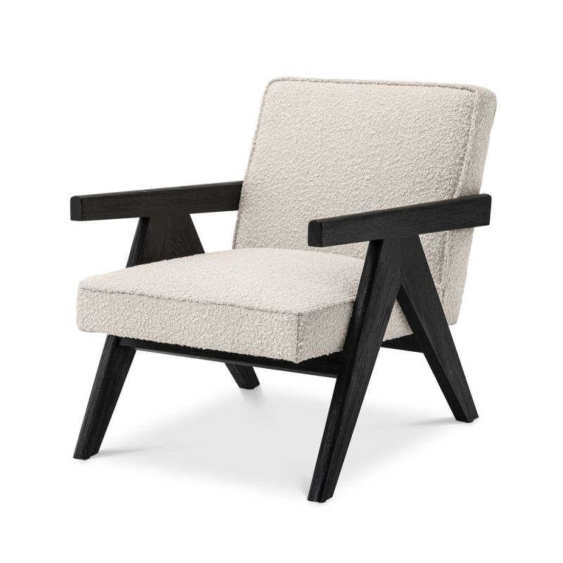 A luxurious boucle armchair with black legs 