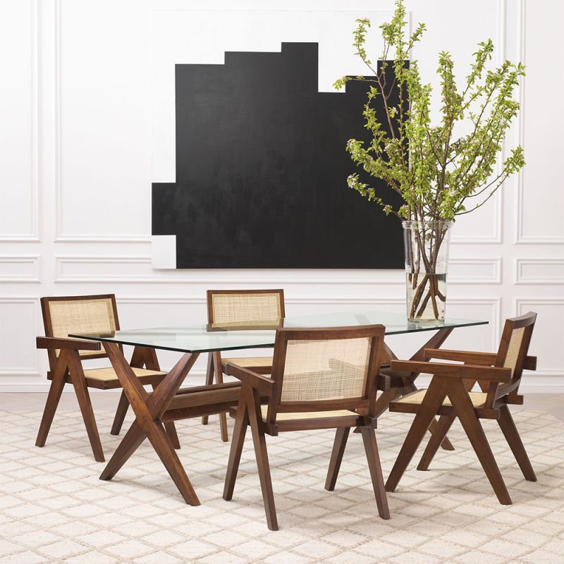 An iconic, brown Jeanneret-inspired dining chair with a rattan seat and backrest
