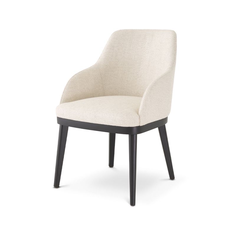 A luxurious dining chair by Eichholtz with a Pausa Natural upholstery and sleek black tapered legs 