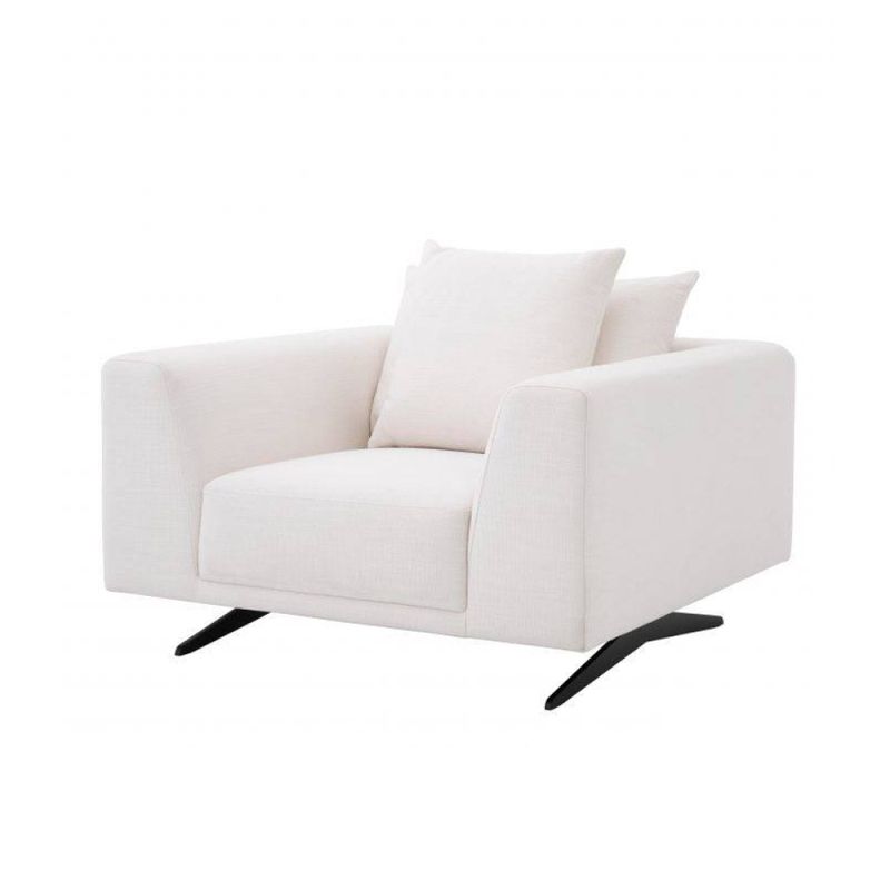A luxurious contemporary armchair with white upholstery and contrasting black legs 