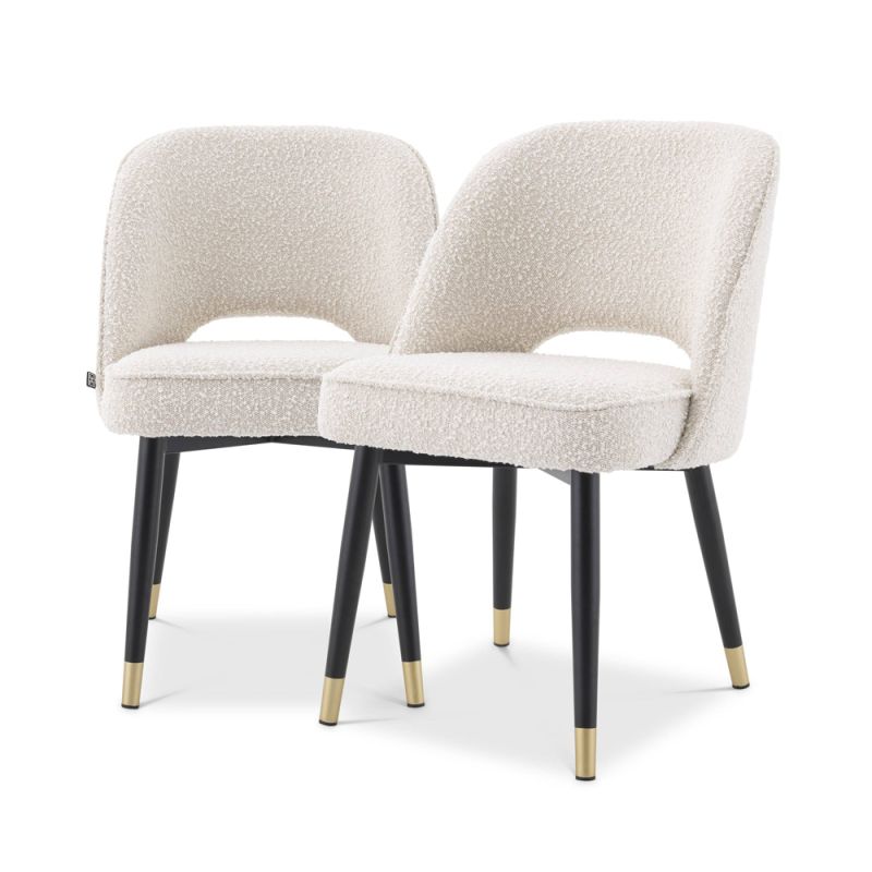 Luxurious Eichholtz dining chairs in a boucle cream fabric with black legs