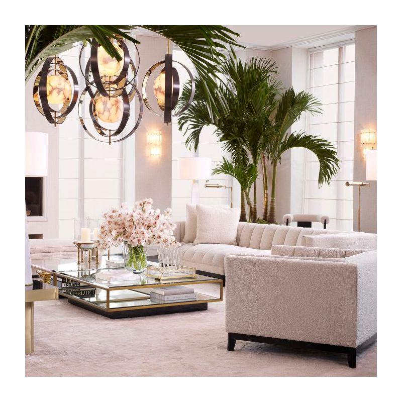 The Ryan Coffee Table combines brushed brass and clear bevelled glass with a mirrored shelf, accessible via a glass door.