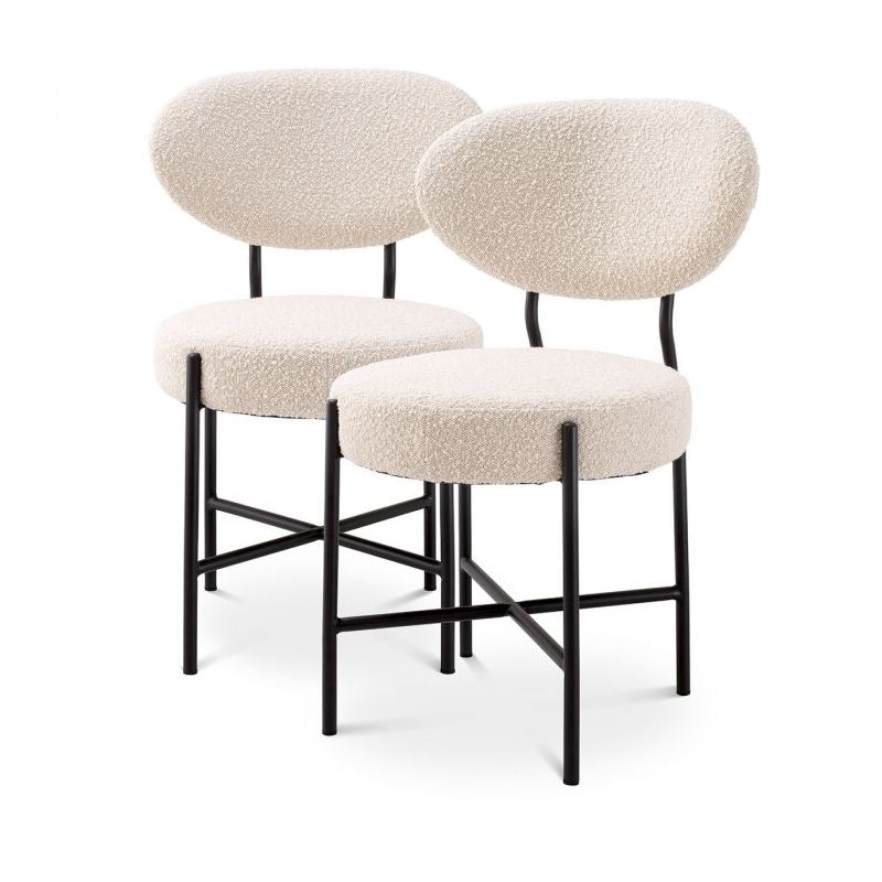 Set of 2 mid-century modern style dining chairs, upholstered in boucle cream with black metal legs.
