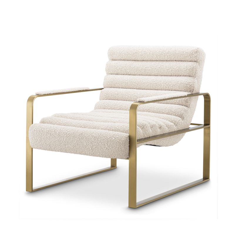 A luxurious boucle upholstered armchair with a brushed brass base