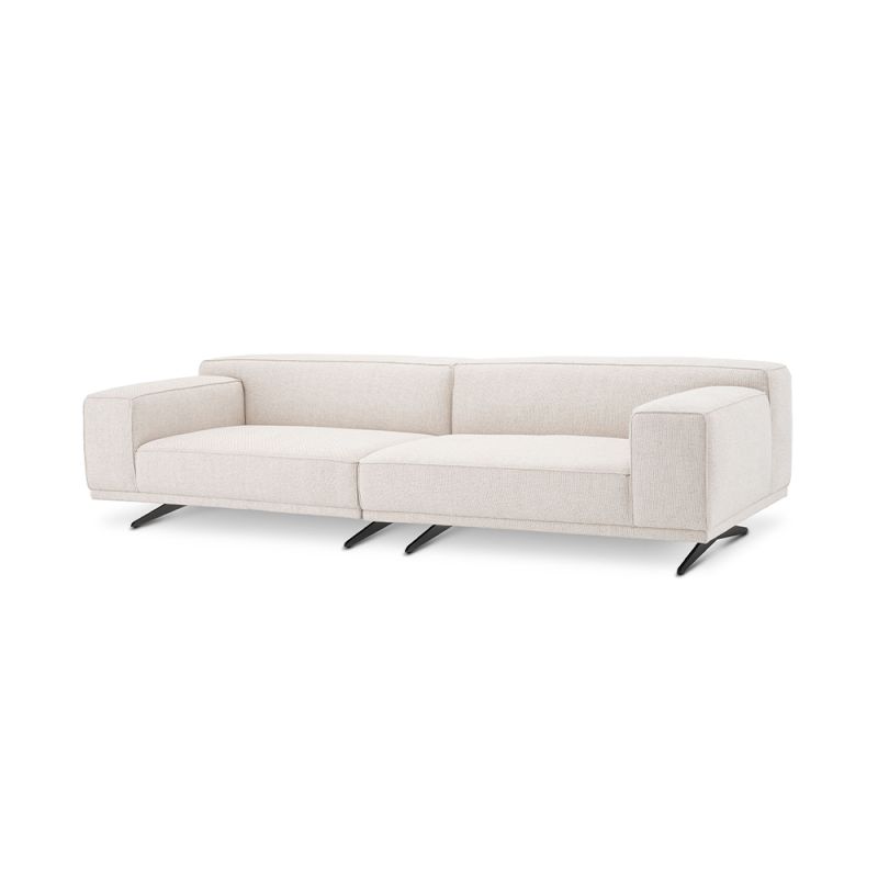 A gorgeous sofa by Eichholtz with a Pausa Natural upholstery, piping and curved black legs