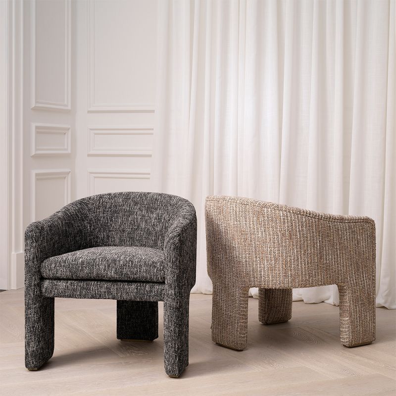 A contemporary retro-styled armchair by Eichholtz with a sumptuous upholstery
