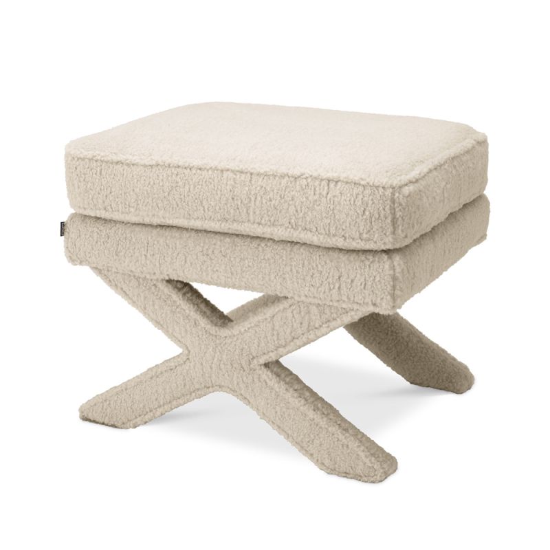 A fluffy, brisbane cream ottoman with x-shaped legs