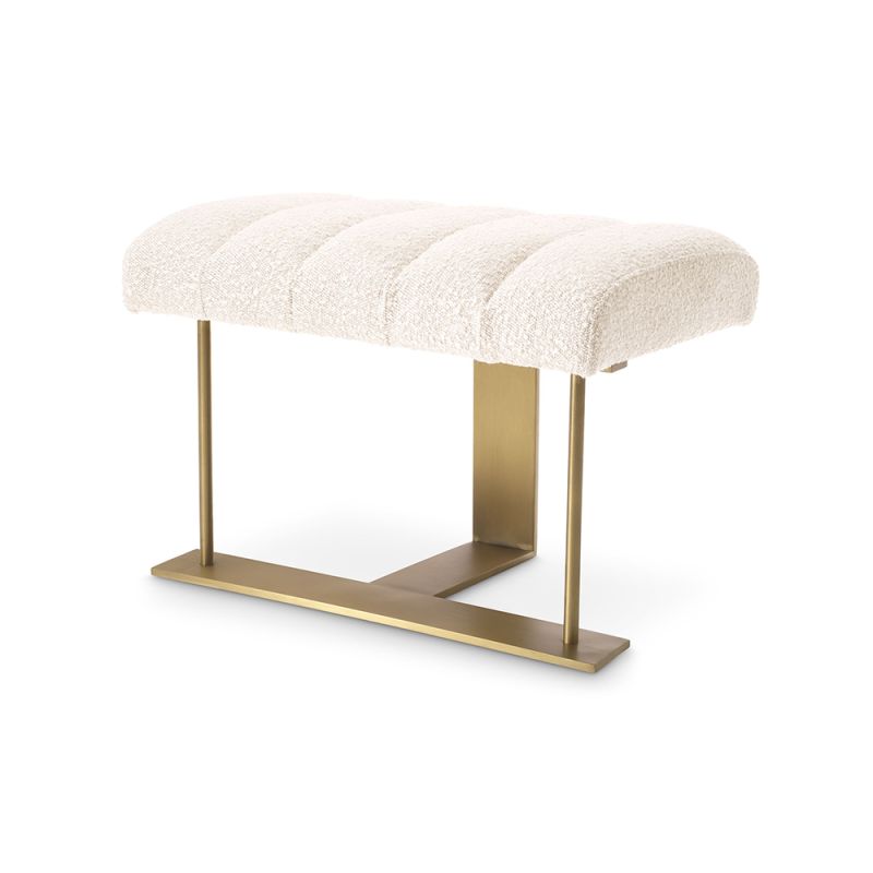 A gorgeous stool by Eichholtz with a boucle cream upholstery, deep channelled stitching and a brushed brass frame