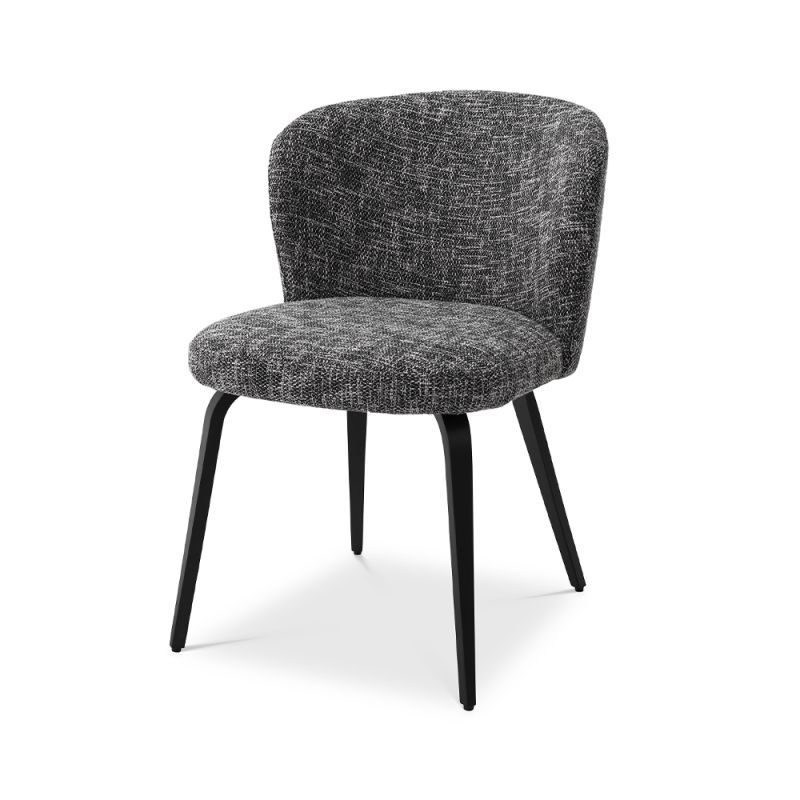 A divine dining chair by Eichholtz with a chic Cambon Black upholstery, sleek black tapered legs and an alluring arched back