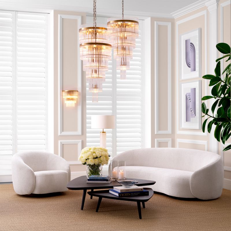 Gorgeous off-white sofa with a black base and curved back