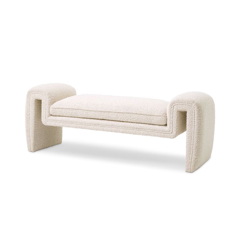 A luxurious bench by Eichholtz with a unique, free flowing design and bouclé cream upholstery