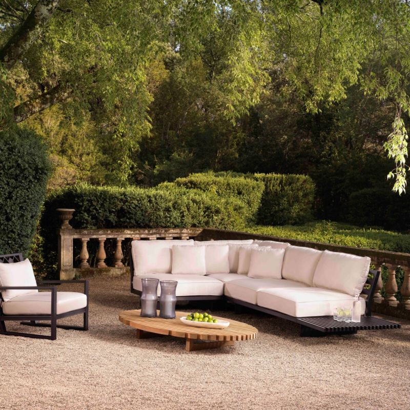 A sophisticated and slatted natural teak outdoor coffee table by Eichholtz