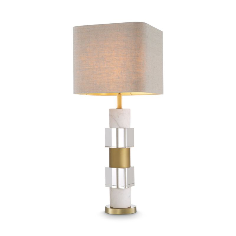 A stylish table lamp by Eichholtz featuring a luxury linen mix shade and marble, crystal glass base with an antique brass finish 