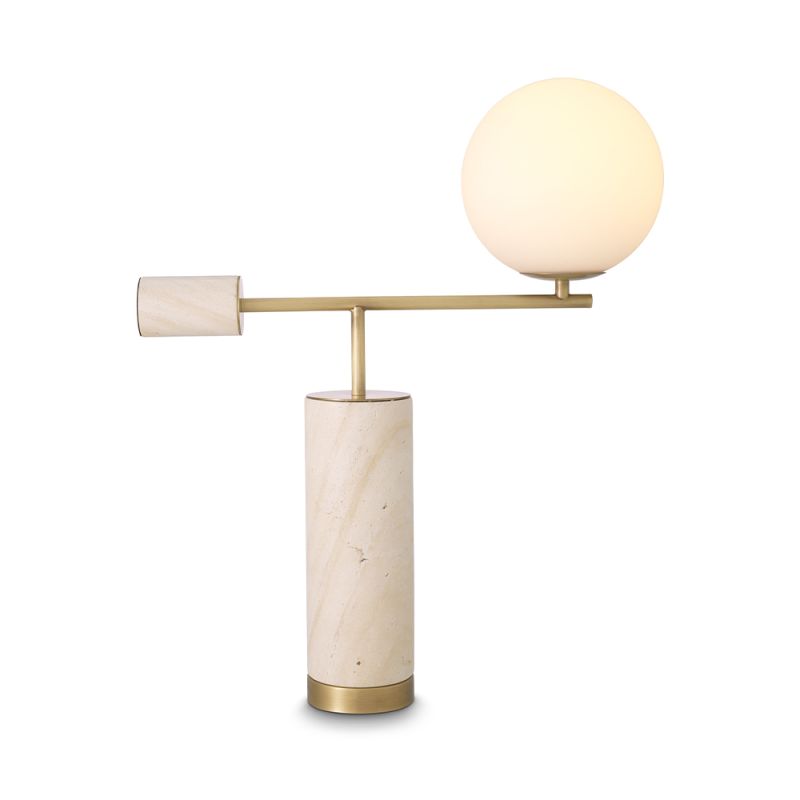 A sculptural side lamp by Eichholtz crafted from travertine with a spherical white glass shade and antique brass finish