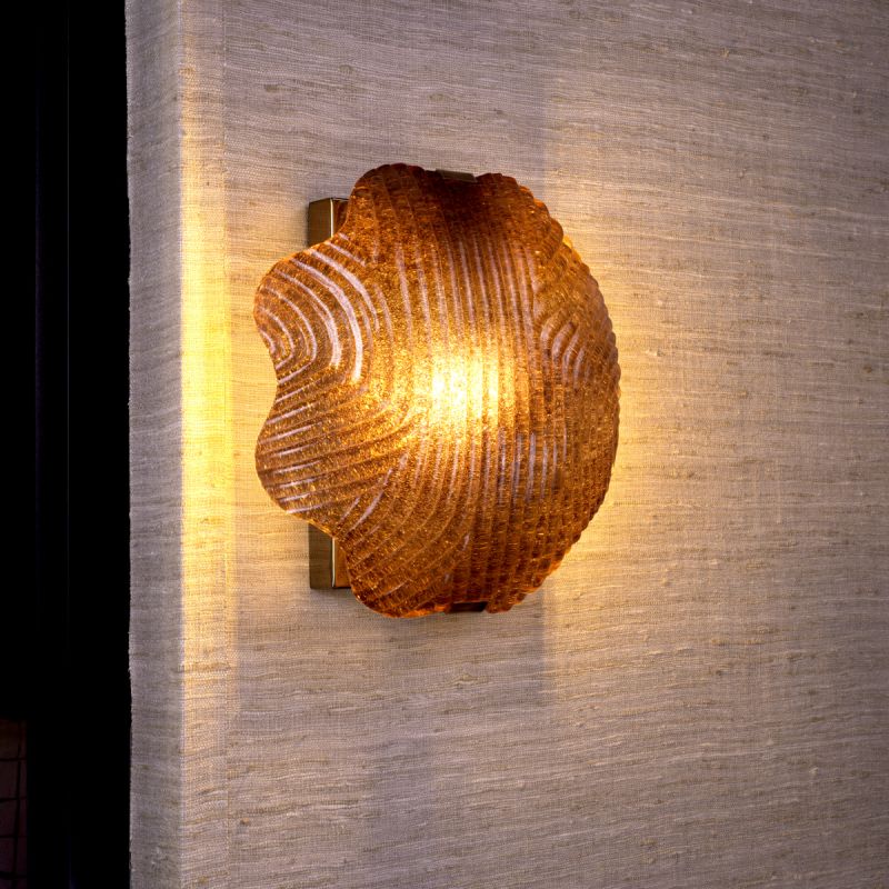 Gorgeous wall light featuring frosted glass and antique brass accents