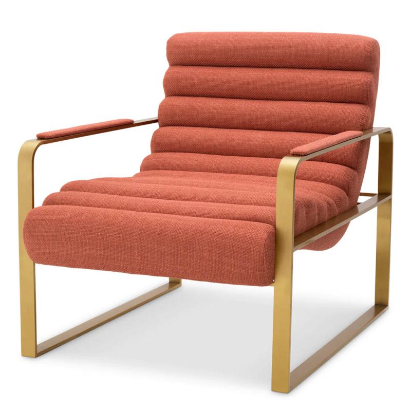 orange linen upholstered armchair with horizontal fluting and brass frame