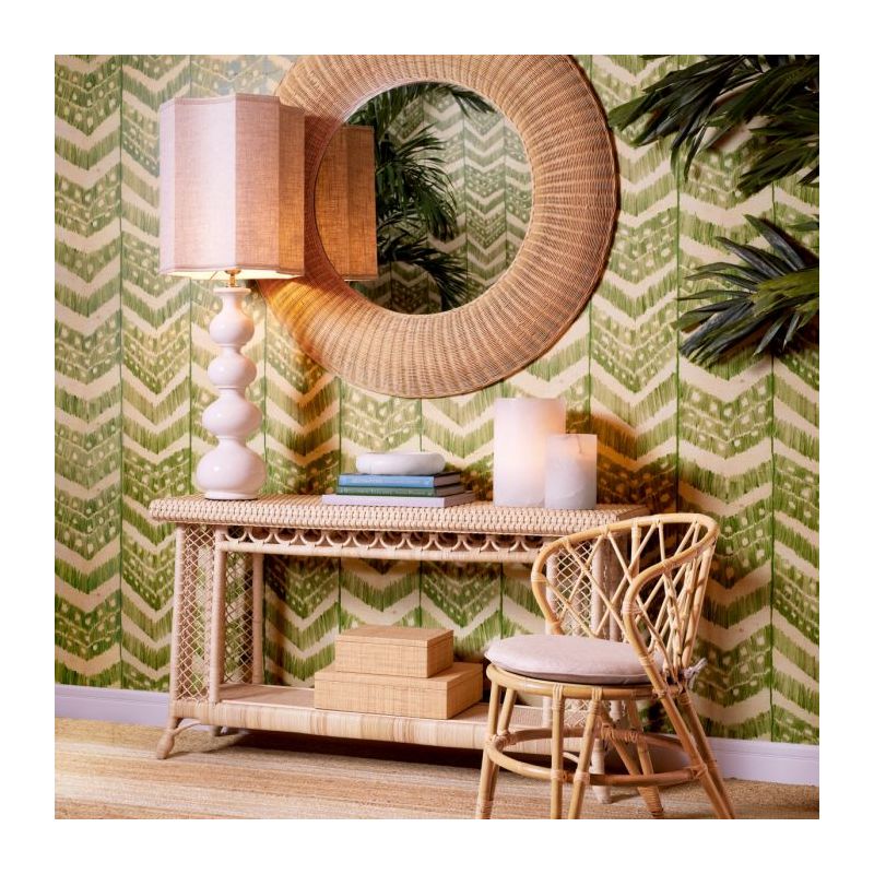 A round handwoven rattan mirror with a warm tone finish
