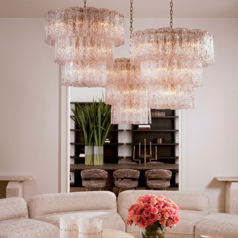 Divine and opulent chandelier featuring textured layered grass and brushed brass accents