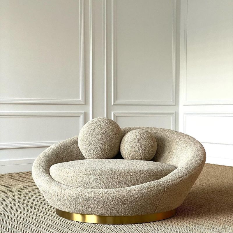 A sumptuous sofa by Eichholtz with a brushed brass base