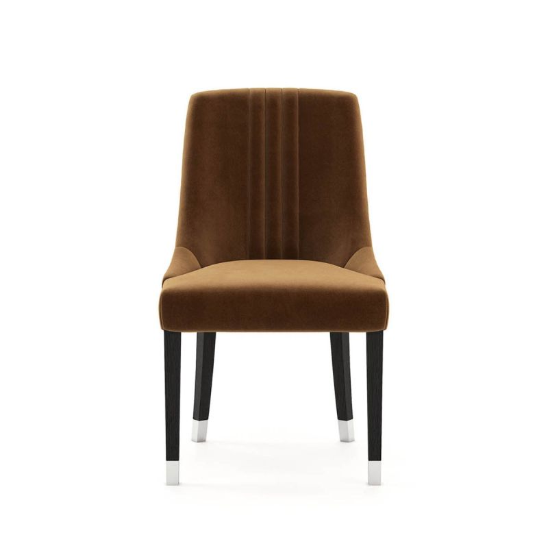 A timelessly elegant dining chair upholstered in velvet with black legs and golden caps. Pictured in Vienna Teja.