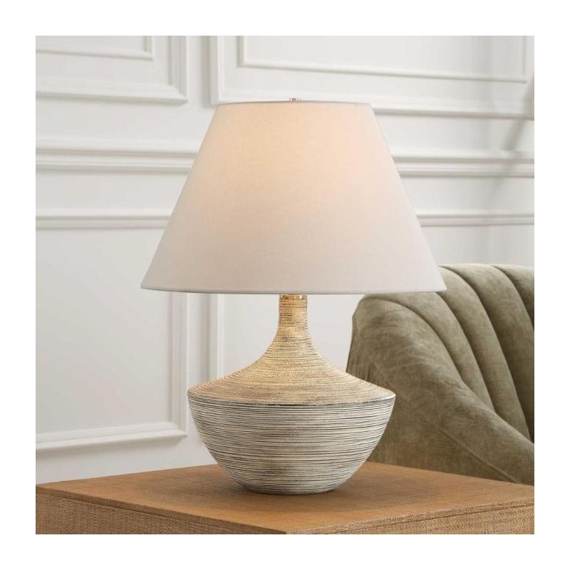 Table lamp with natural style curvaceous base and cream shade