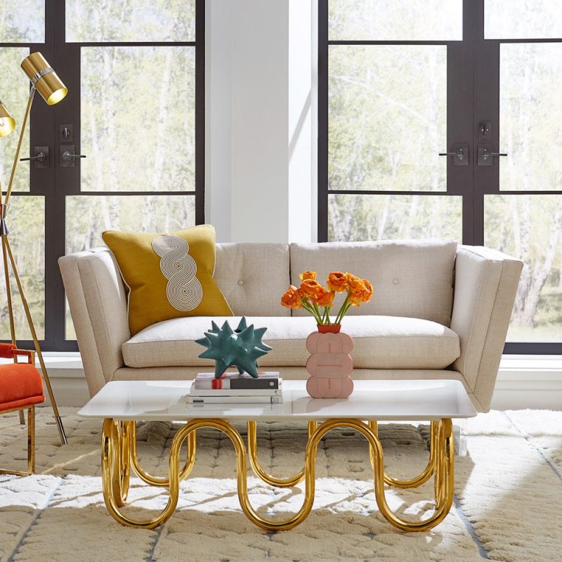 Luxurious coffee table with wave effect legs in polished brass finish