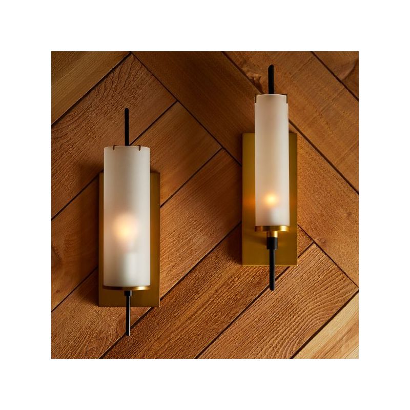 Cylindrical wall sconce mounted on brass panel base