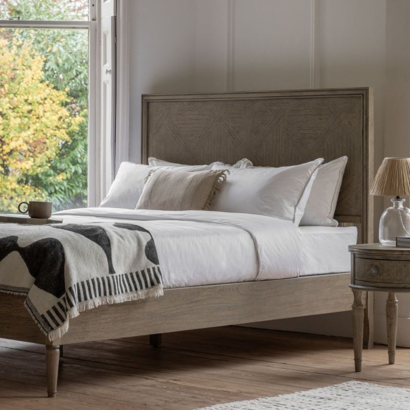 Light wooden king size bed with cross pattern on headboard