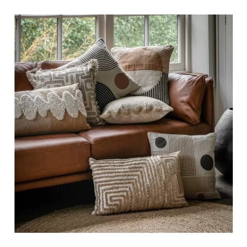 Square cushion with yellow and black circular and striped abstract design