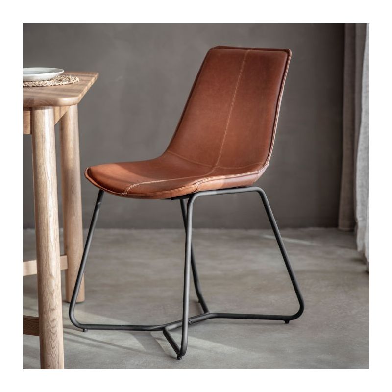 Scooped brown leather chair with black metal legs