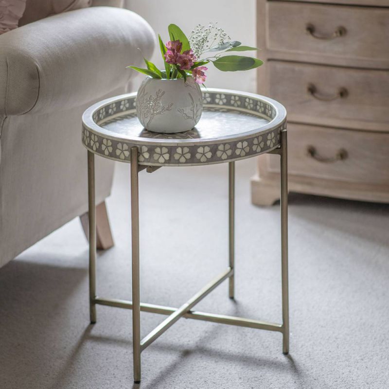 Round floral detailed grey bone side table with four iron legs