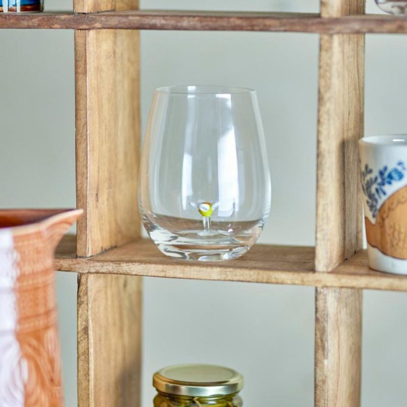 Clear drinking glass with flower at base
