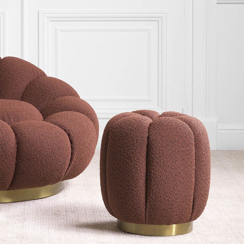 Striking rouge pouffe with boucle textured finish and glamorous brass plinth base