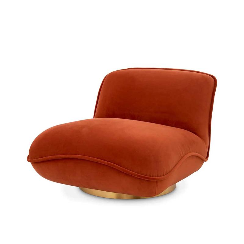 A beautiful upholstered savona orange velvet chair by Eichholtz with a brushed brass base 