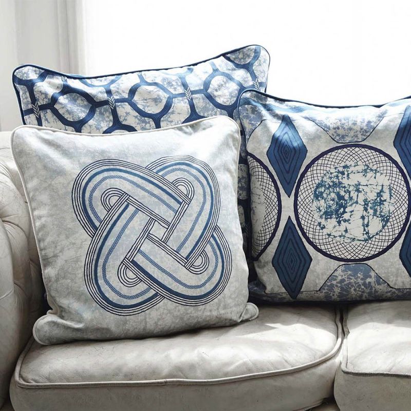 A luxury cushion by Eva Sonaike with a blue African-inspired pattern