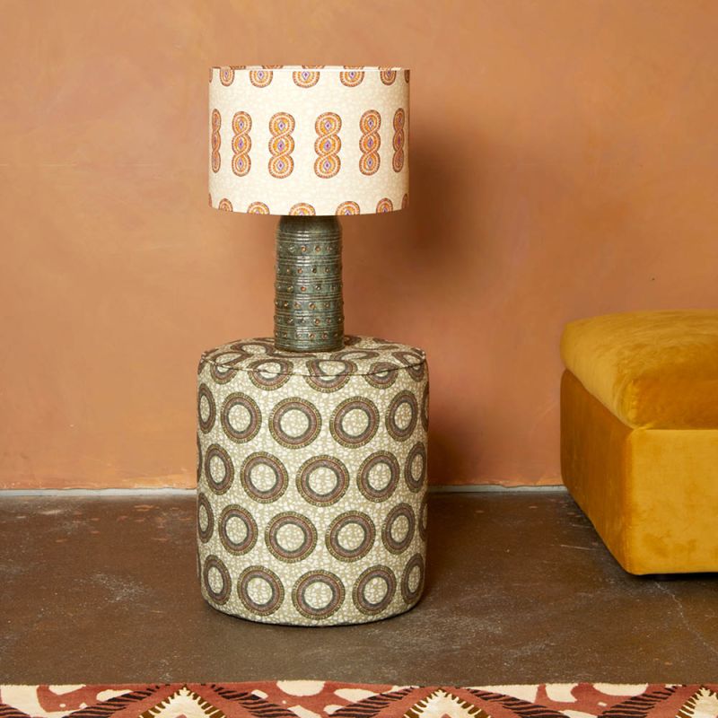 A luxury lampshade by Eva Sonaike with an orange African-inspired pattern