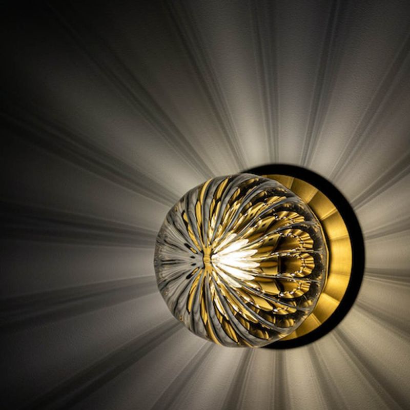 Round wall sconce with transparent glass shade with a gorgeous natural brushed brass finish