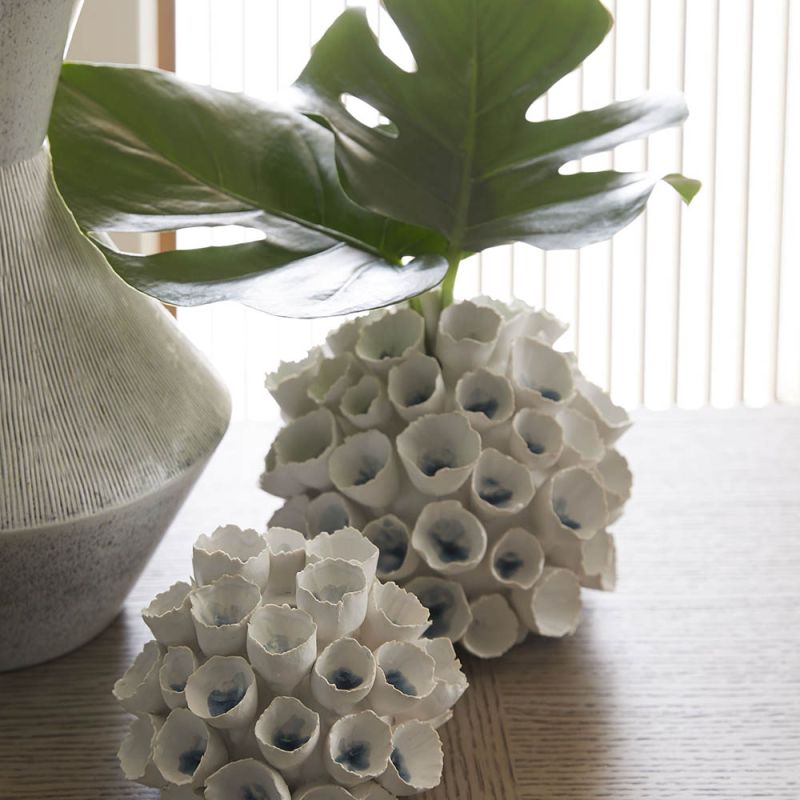 Set of two white flower-like vases with blue centres 