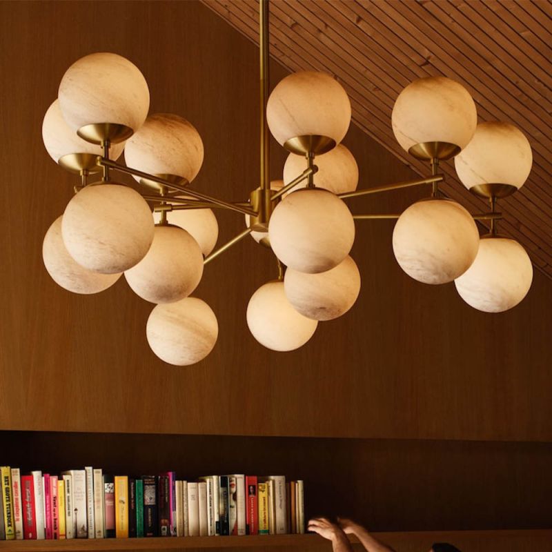 Extravagant marble and brass chandelier with orb-shaped shades