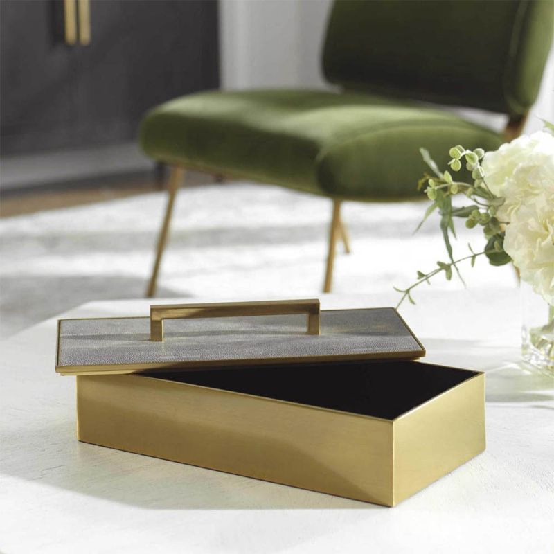 A glamorous brass box by Uttermost with a grey faux shagreen finish 