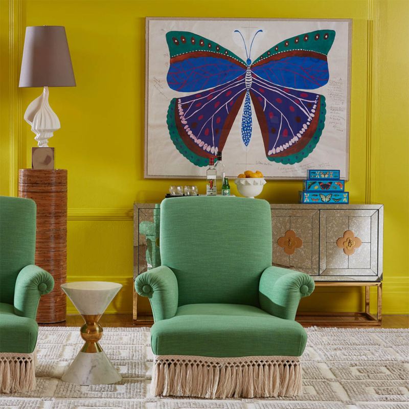 Green armchair with cream fringe bottom