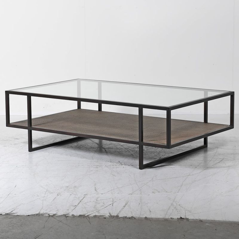 A luxurious two-tier coffee table with a  glass surface and wicker/mdf lower shelf