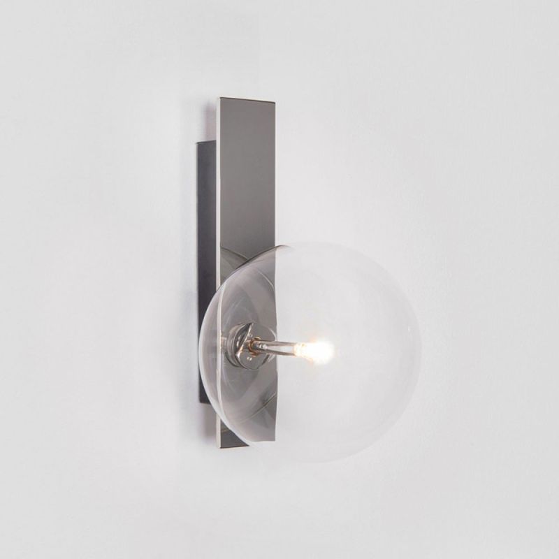 A chic polished nickel wall lamp with a transparent glass lampshade