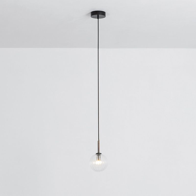 Textured clear glass globe pendant ceiling light with black brass fixture